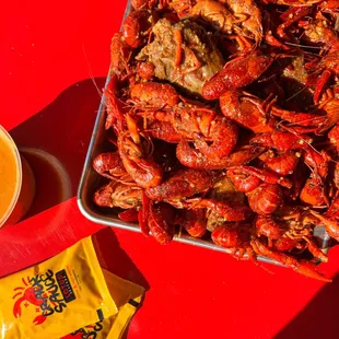 a tray of lobsters and a bowl of soup
