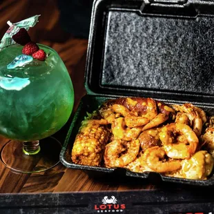 a green drink and a tray of chicken wings