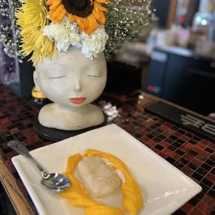 a plate of food and a vase of flowers