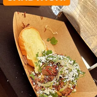 Chopped Brisket Sandwich with Grilled onions, cilantro, Queso Fresco Cheese, and BBQ Sauce
