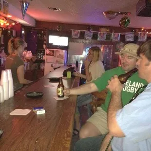 a group of people sitting at a bar