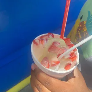 ows a child holding a cup of ice cream