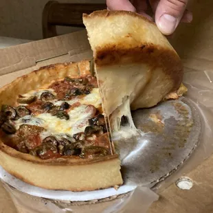 Undercooked pizza sticking to box