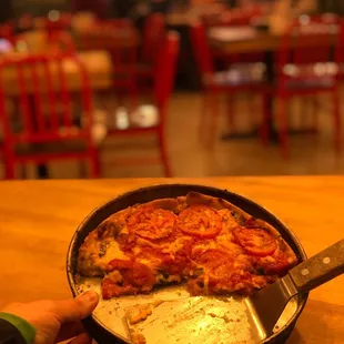  pan of pizza with a slice taken out of it