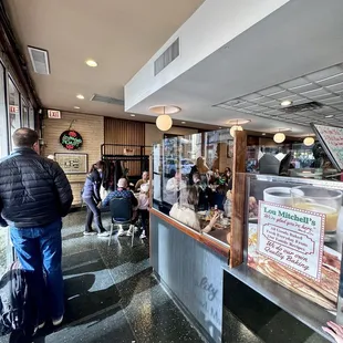 people sitting at tables in a restaurant