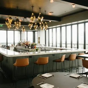 a view of a bar with chairs and tables