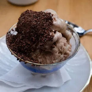 a bowl of ice cream with chocolate topping