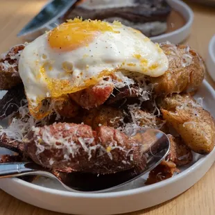 a plate of food with a fried egg on top