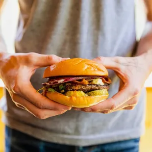 a man holding a hamburger