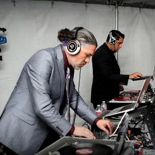 DJs Elixir and Cali tag-teaming on four turntables for the ultimate DJ experience!  Not your typical wedding DJs! Photo: Aleasha Aguilar