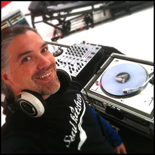 Main DJ and Loud DJs owner Eric P. snaps a selfie before going live at a fitness studio broadcast in Burbank with Lagree Fitness