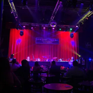 a stage with a red curtain