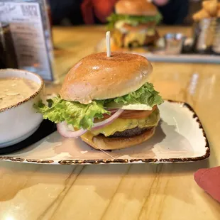 a hamburger and a cup of coffee