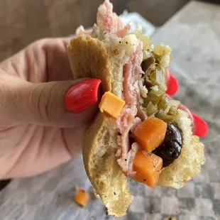 Savoring the last bites of this muffuletta!!!! Yum!