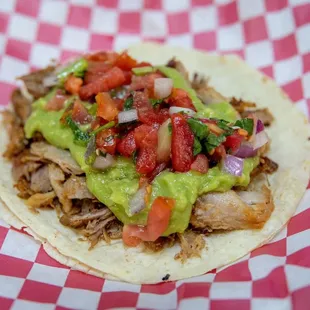 Carnitas taco Cali style come with guacamole and pico the gallo