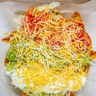 Taco salad choice of meat, comes with guacamole pico de gallo sour cream, shredded cheese, rice,