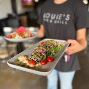 a person holding a plate of food