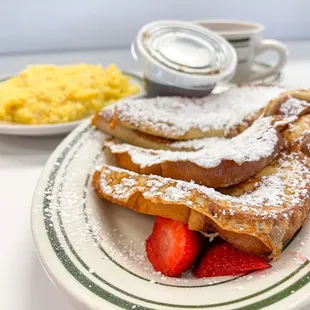 a plate of french toast and strawberries