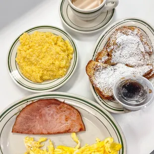 a breakfast of eggs, ham, scrambled eggs and coffee