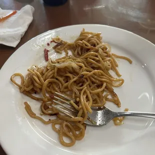 This photo is a play with chow mein and a fork.