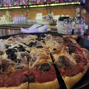 a pizza with olives and onions