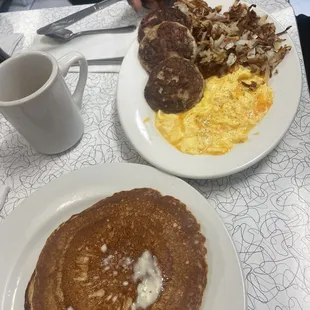 Scrambled eggs hash browns turkey patties and pancakes