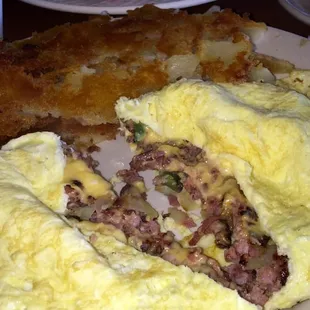 Louie&apos;s Mistake, a fluffy omlet stuffed with corned beef, ham, green pepper, onions &amp; a layer of love that is melted cheese.