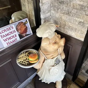a statue of a chef holding a plate of food