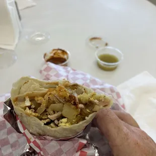 Super Breakfast Burrito, red hot sauce so hot so good. Green sweet no heat.