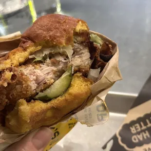 Fried chicken sandwich mid-bite at the Louie's counter!