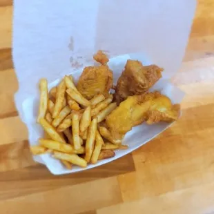 a basket of fried fish and fries