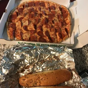 two hot dogs and a pepperoni pizza