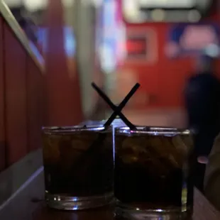 two glasses of soda on a table