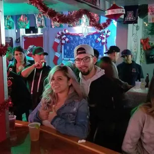 a group of people sitting at a bar