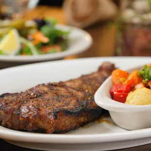 a plate of steak and vegetables