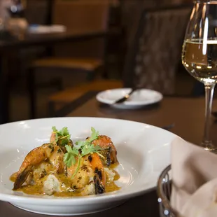 a plate of food and a glass of wine