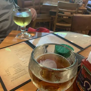 a glass of beer and a menu