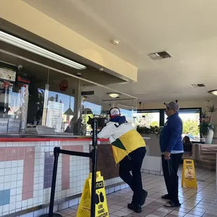 a man and a woman standing in front of a counter