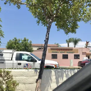 Was hungry truck about to get in drive-through line or eyeing the store across the street?
