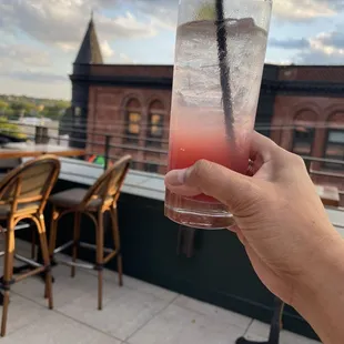 a hand holding a drink