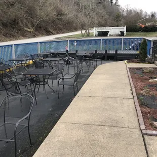 a patio area with tables and chairs