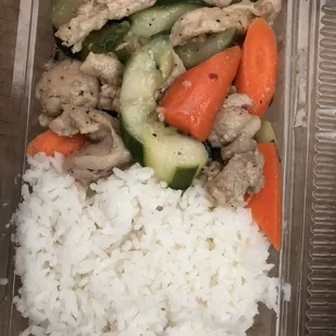 a plastic container with rice and vegetables