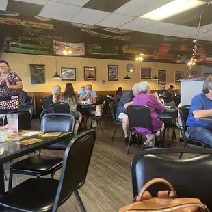 people sitting at tables in a restaurant