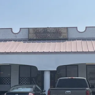 two cars parked in front of a restaurant