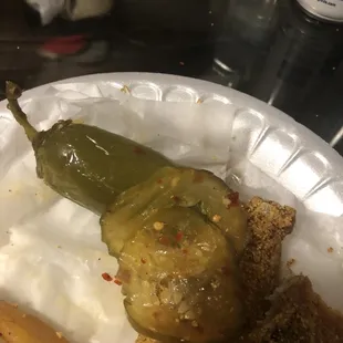 a pickle on a paper plate