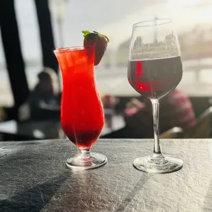 a glass of red wine and a glass of strawberry juice