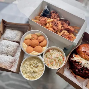 Beignets, oyster basket w/ cajun fries, banana pudding, coleslaw, potato salad, pulled pork sandwich