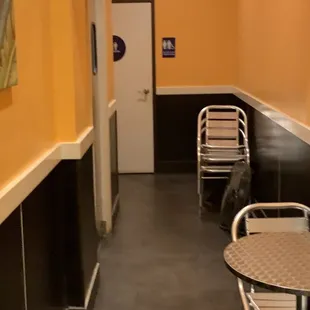 a hallway with tables and chairs