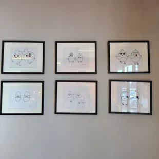 a wall of framed art