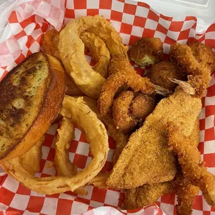 a basket of fried fish and onion rings